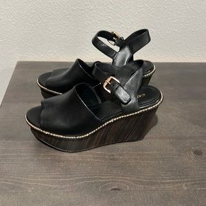 Black leather with gold beading along bottoms of leather with faux wood look